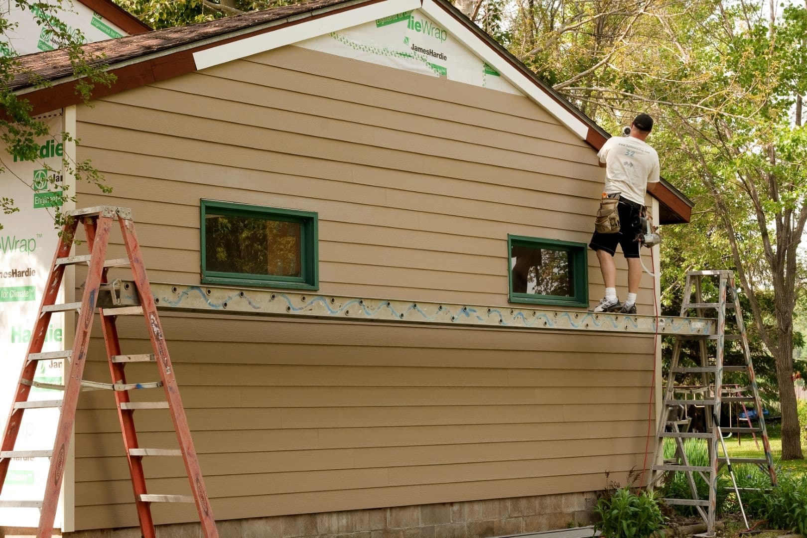 A worker installing siding.