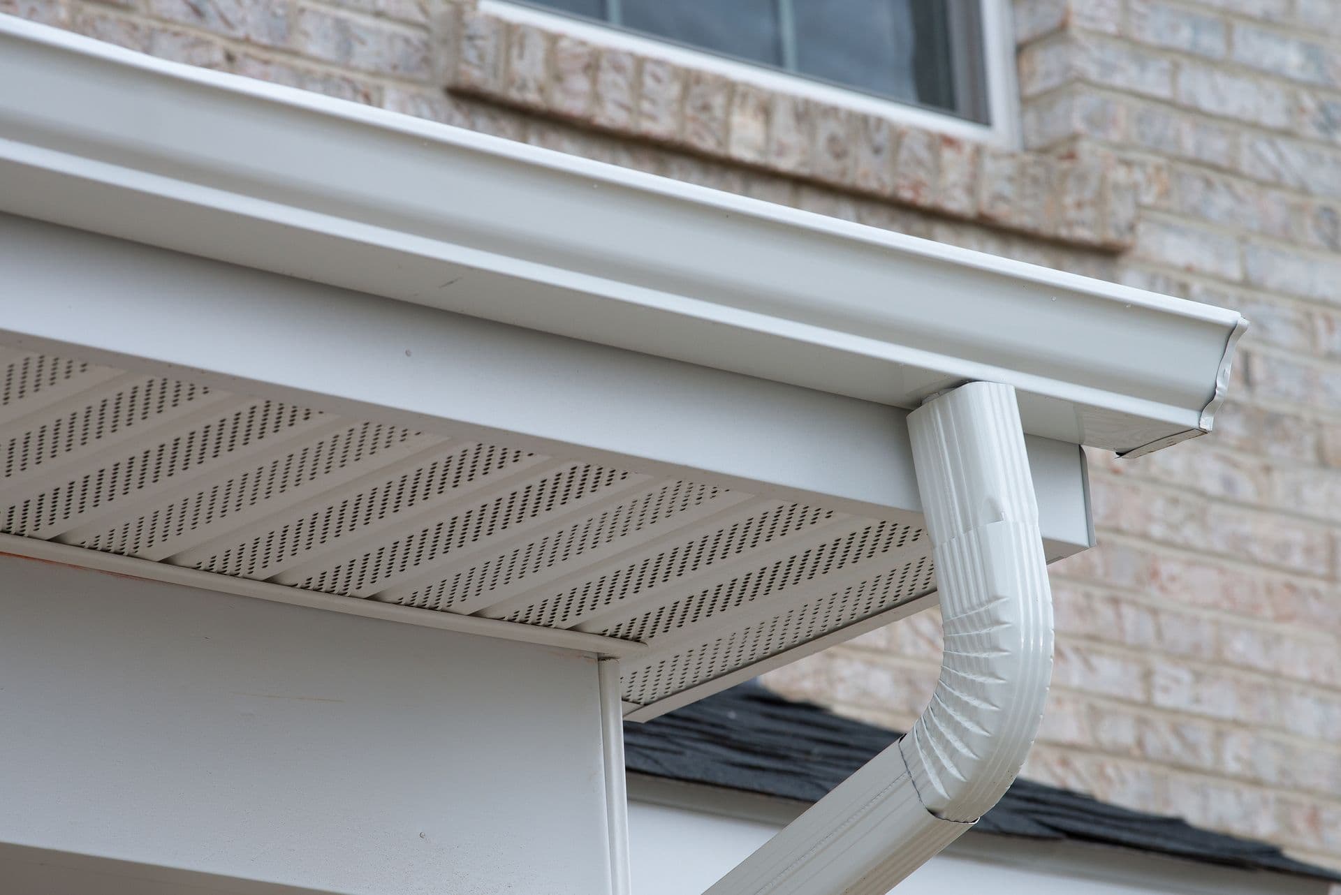 Newly-installed white rain gutters.