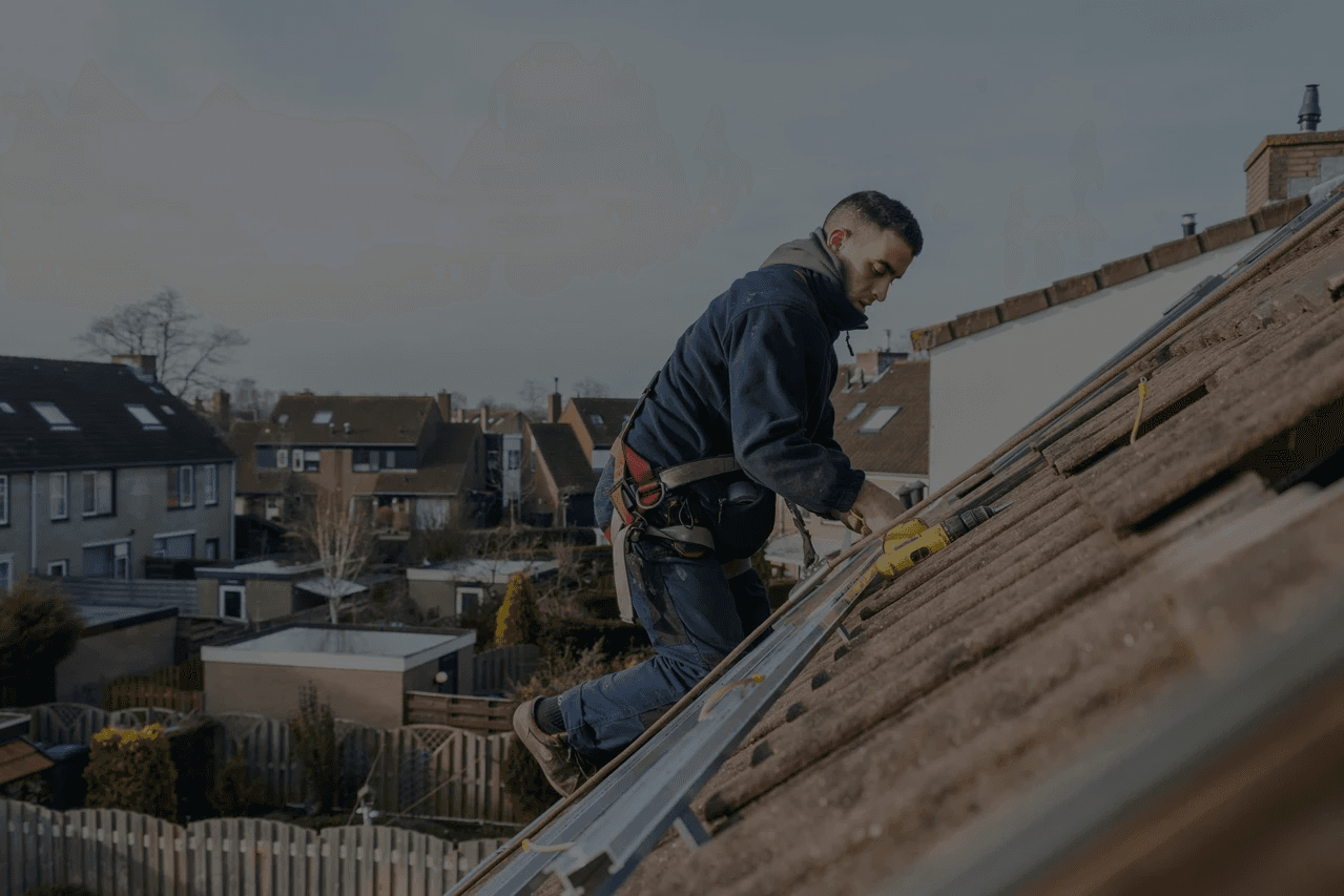 A worker installs roofing.